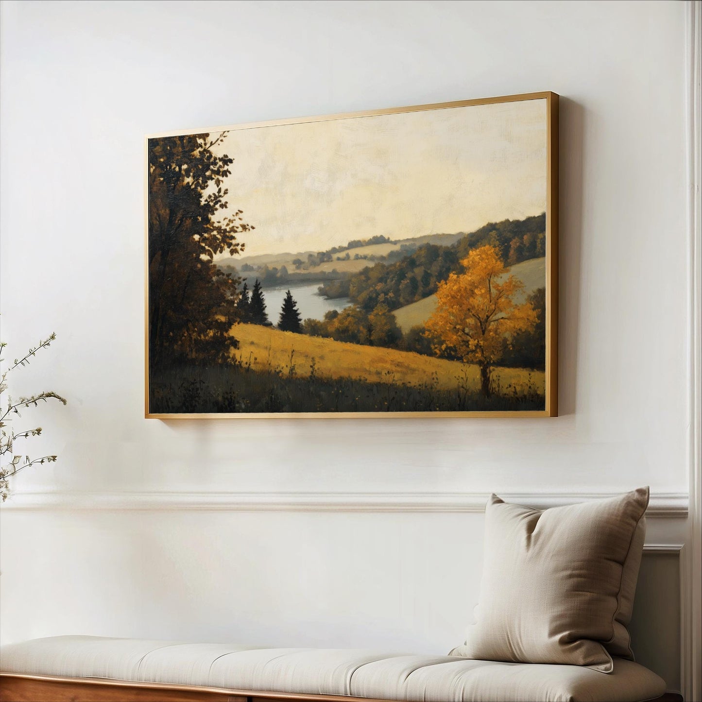 a large landscape painting hanging on a white wall, depicting a serene countryside scene with trees, grass, and a body of water.
