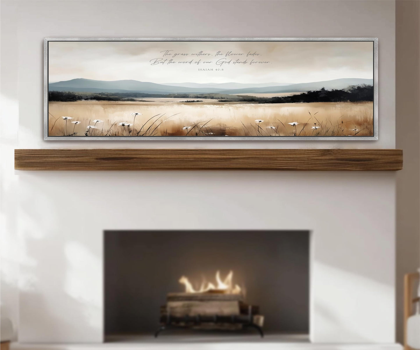 a fireplace with a warm fire burning inside, and a framed landscape painting hanging above it. The painting depicts a serene countryside scene with rolling hills, trees, and a field of flowers. The text "The grass grows tall, the flowers bloom, but the word of our Lord stands forever" is written in the painting.