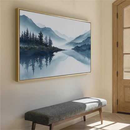 a large landscape painting hanging on a wall, depicting a serene mountain lake surrounded by trees and mountains. In the foreground, there is a gray bench positioned against the wall, providing a seating area for viewers to appreciate the artwork.