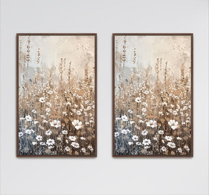two framed paintings of a field of white flowers against a light brown background.