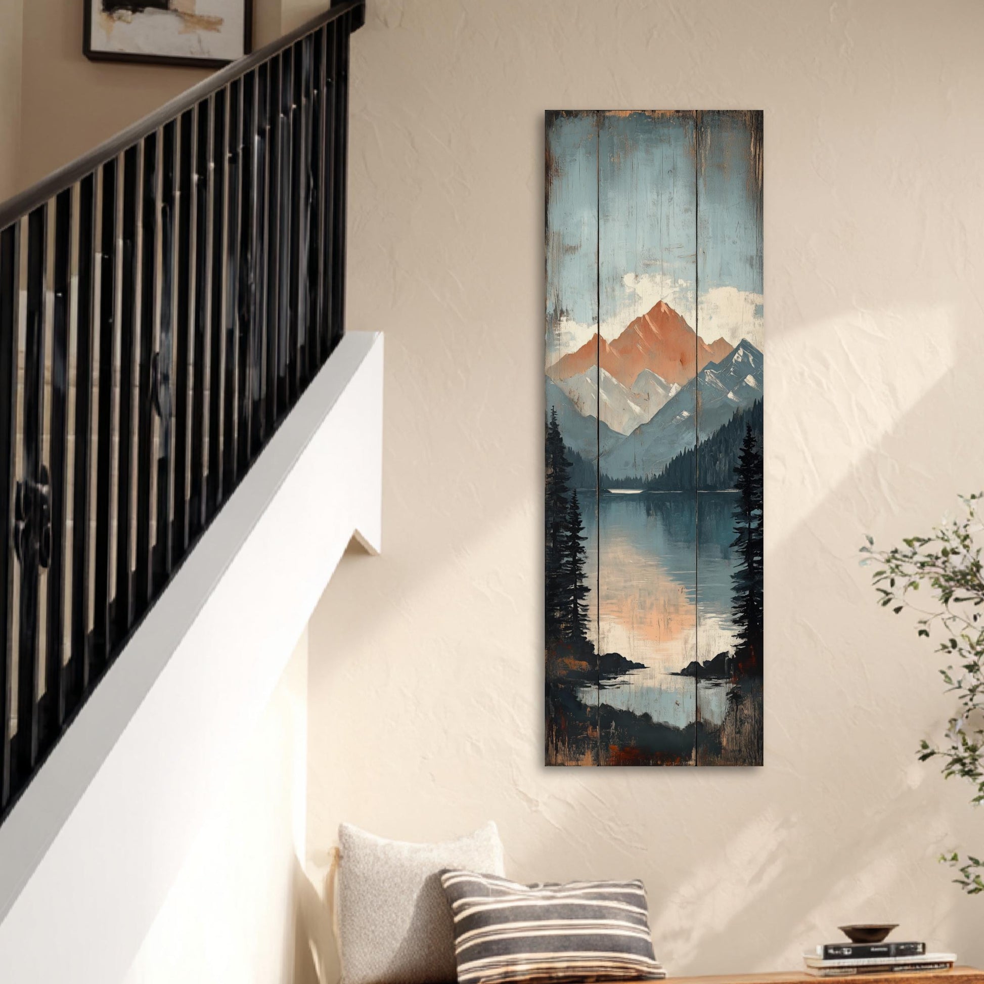 a wall with a large, colorful painting depicting a mountain landscape with a lake and trees. The painting is hanging on the wall, and there is a staircase visible in the background.