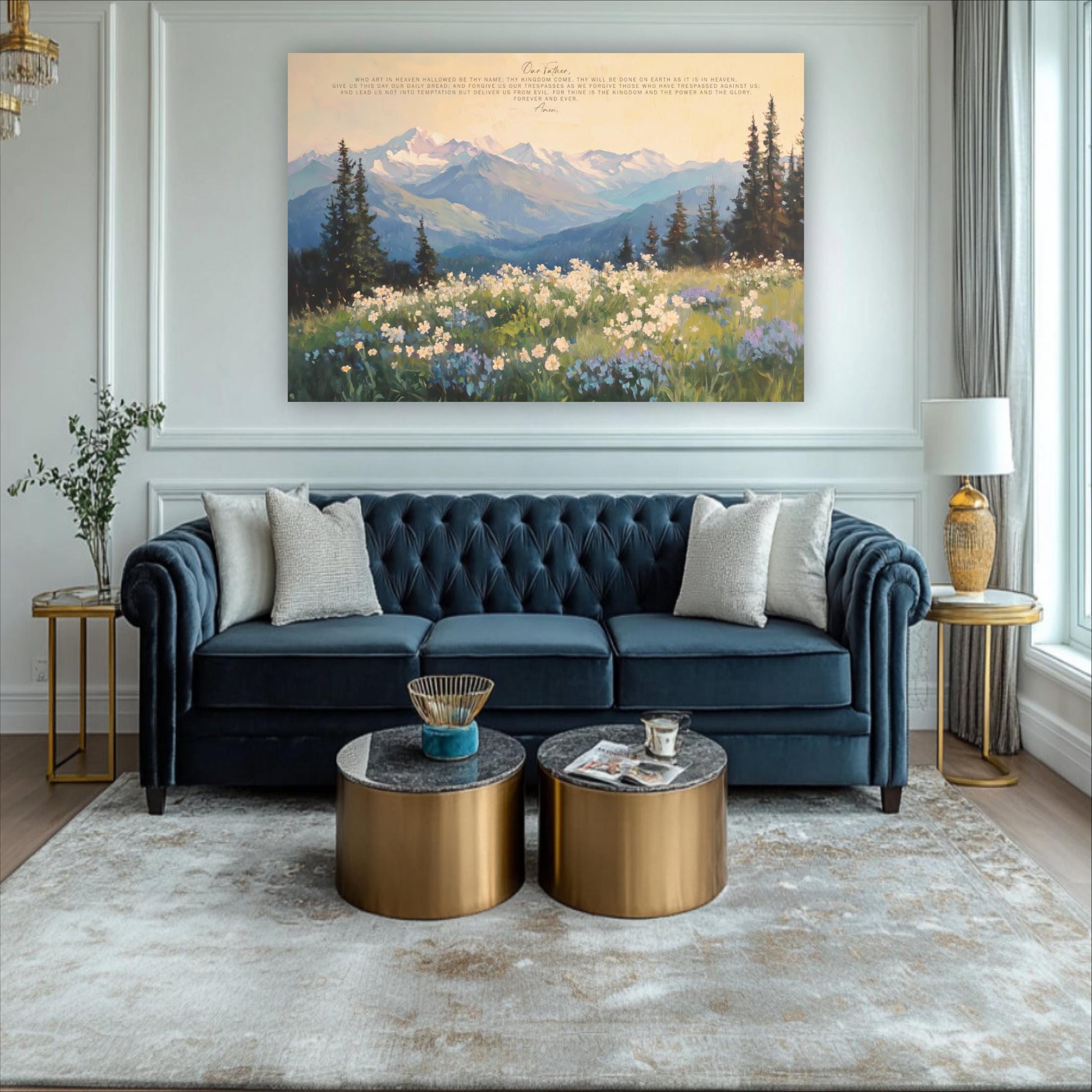 a living room with a blue tufted sofa, two round coffee tables, and a large landscape painting on the wall depicting a mountain and field with flowers.