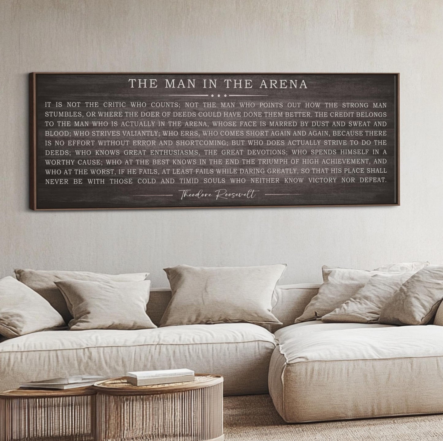 a living room with a white couch and a wooden sign on the wall