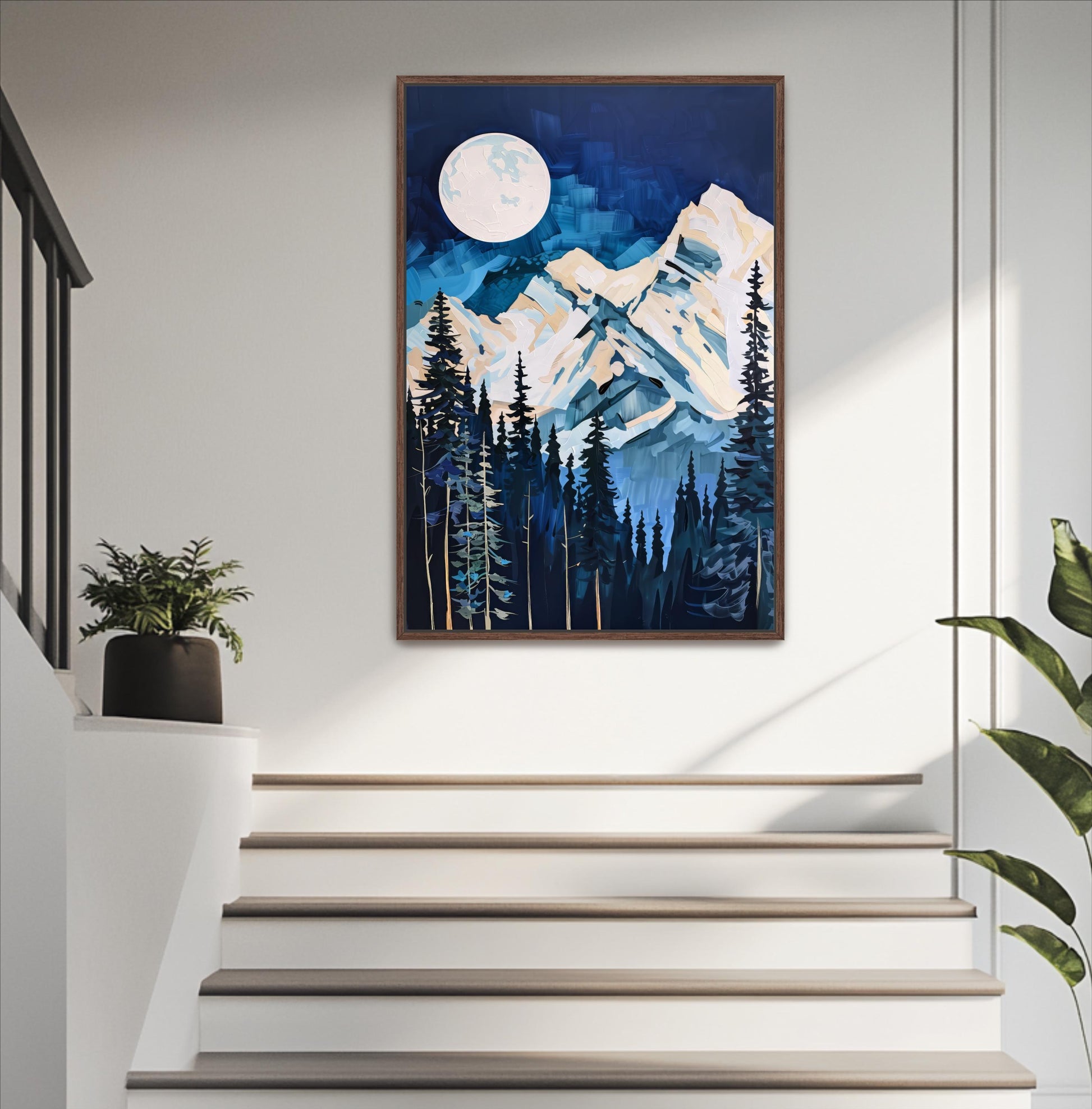 a framed painting of a mountain landscape with a full moon in the night sky, hanging on a wall above a set of white stairs.