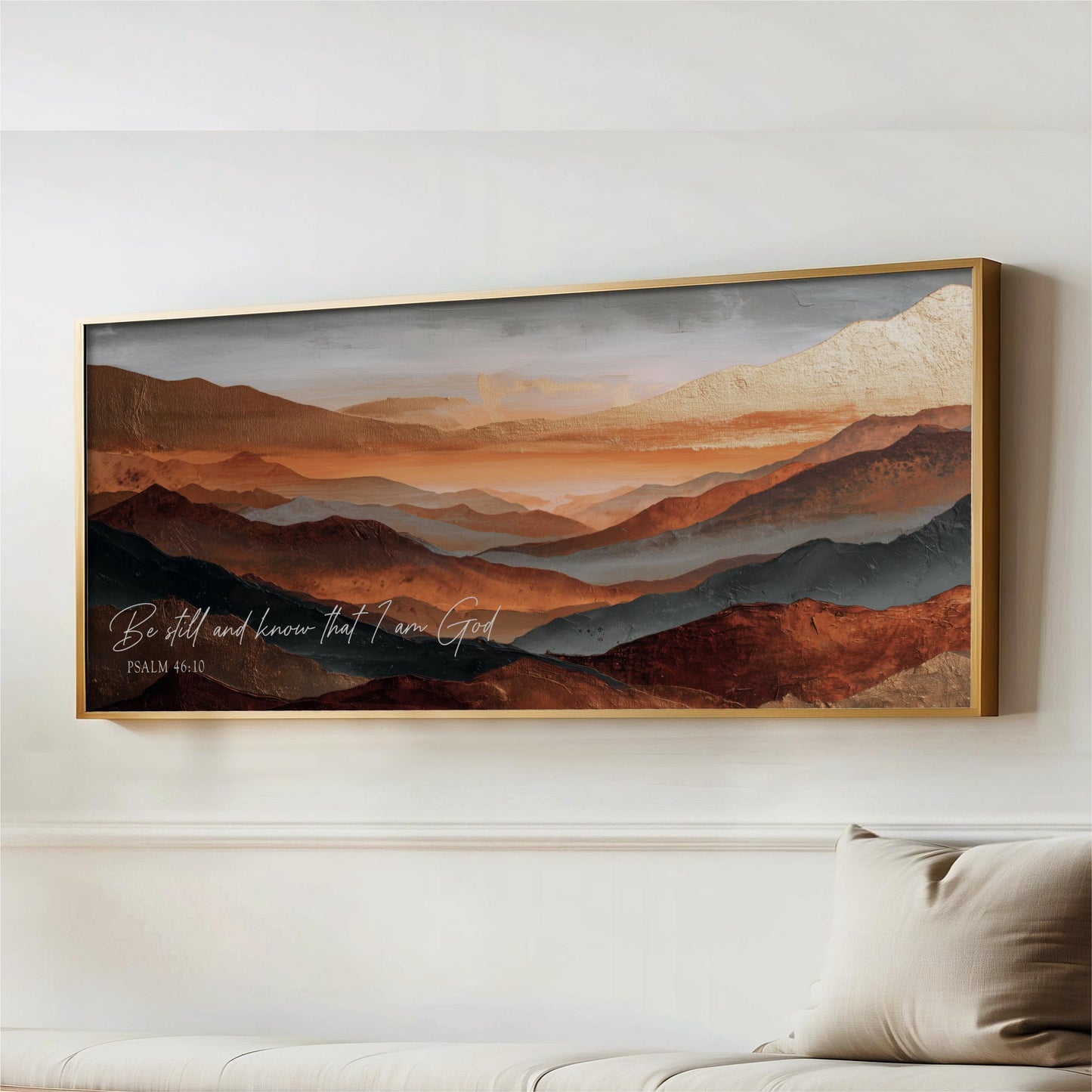 a large framed painting of a mountainous landscape with warm colors, hanging on a wall above a couch.