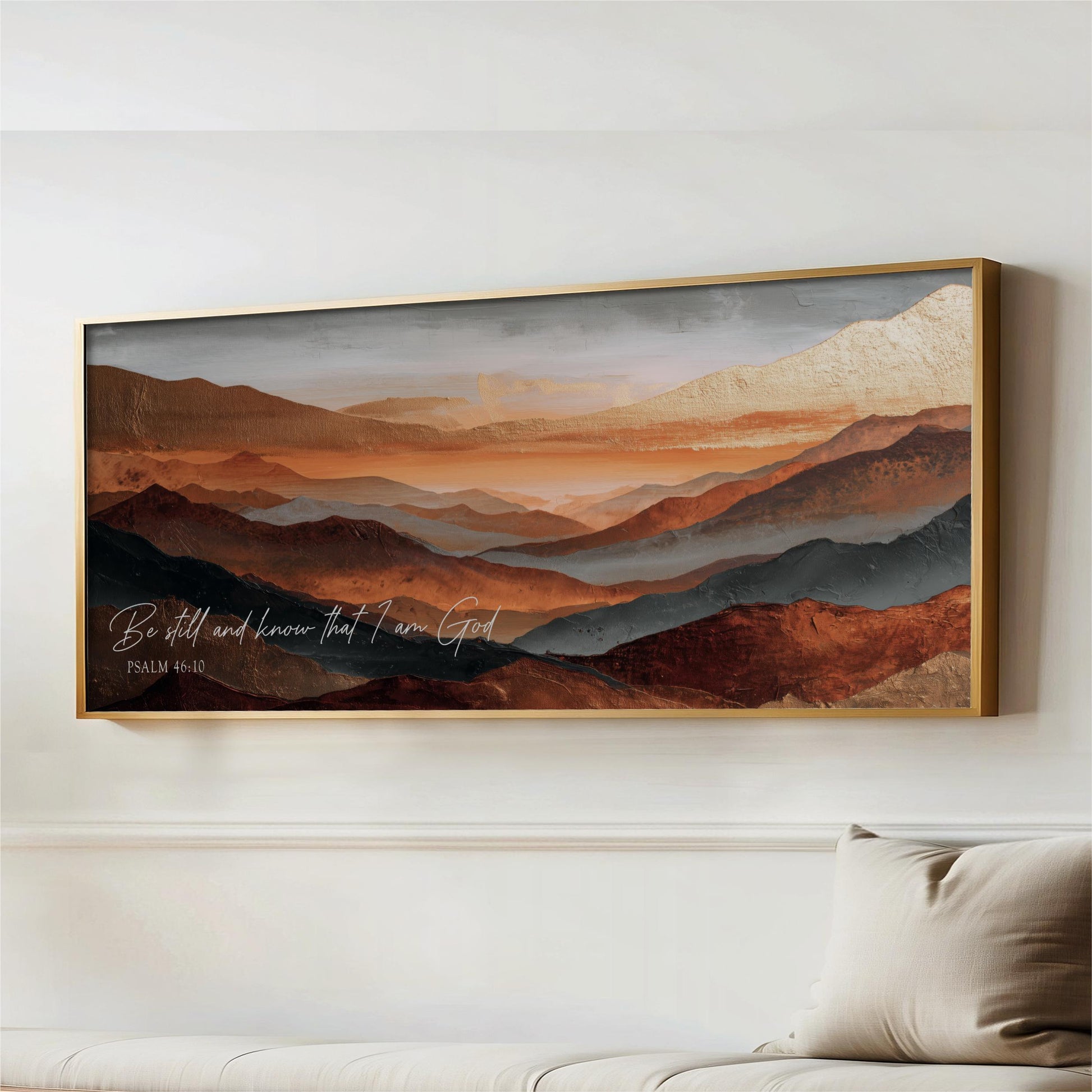 a large framed painting of a mountainous landscape with warm colors, hanging on a wall above a couch.
