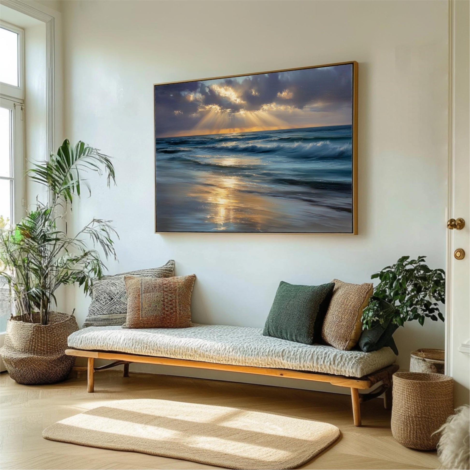 a serene living room with a large painting of a beach scene hanging on the wall. The painting captures the ocean at sunset, with the sky filled with clouds and the sun's rays reflecting on the water. The room is decorated with potted plants, a bench, and a rug, creating a cozy and inviting atmosphere.