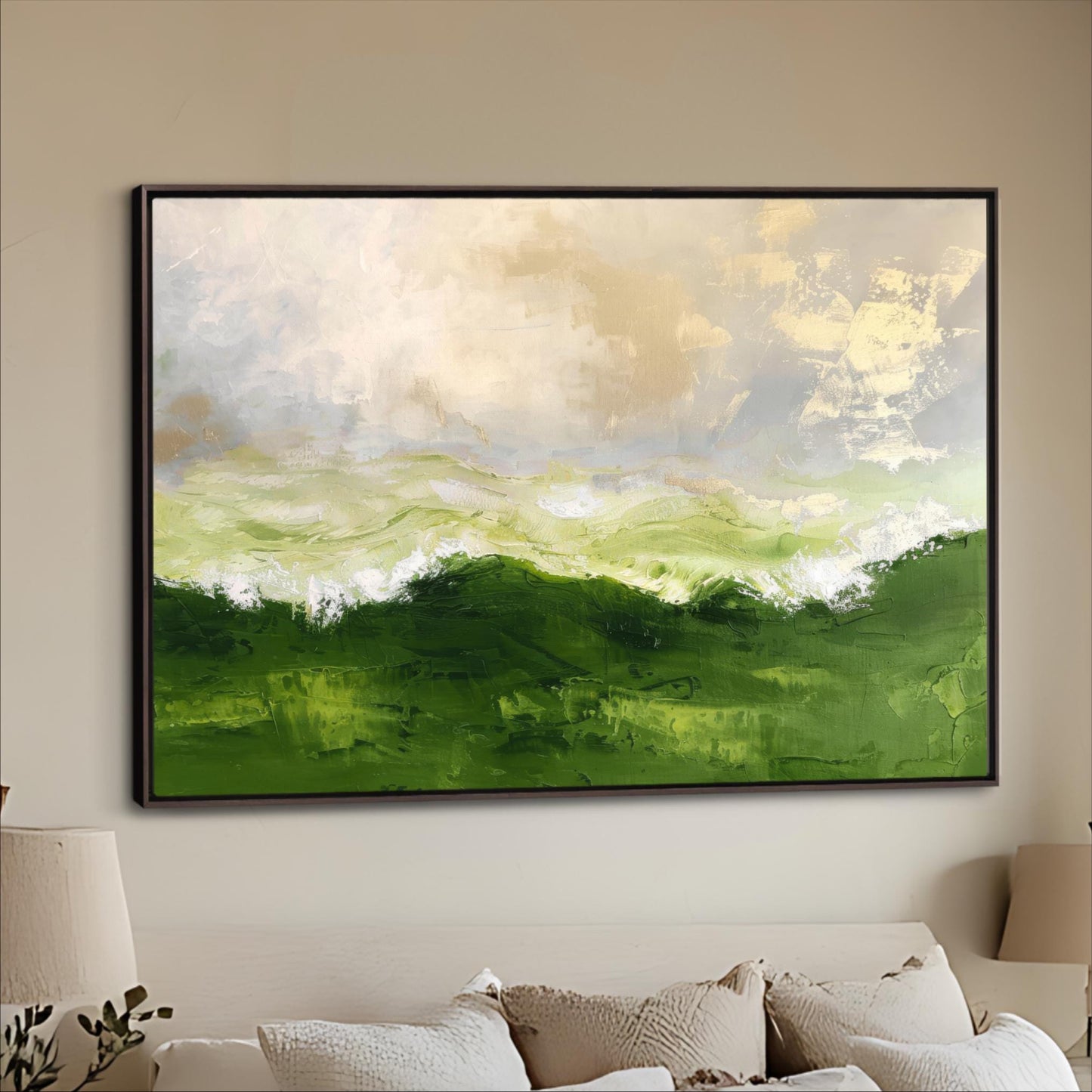 a large, framed painting of a landscape with green hills and a cloudy sky hanging on a wall above a couch.