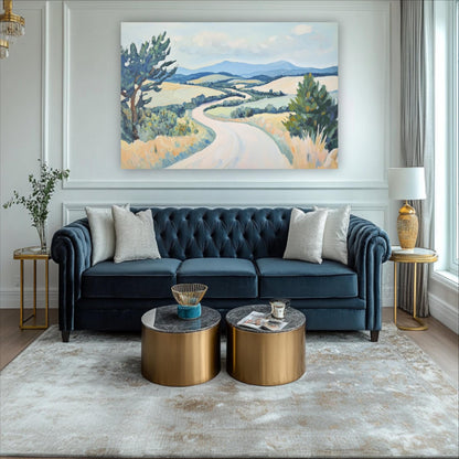 a living room with a blue tufted sofa, two round coffee tables, and a large landscape painting on the wall.