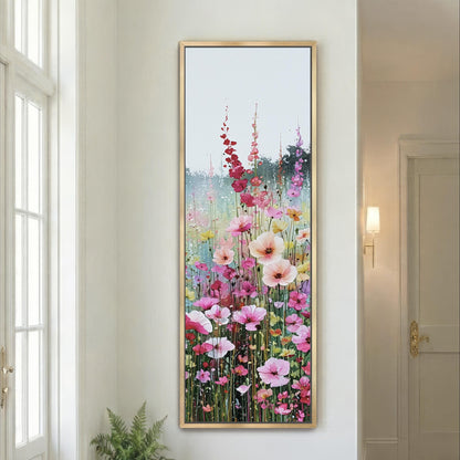 a large, framed painting of a vibrant garden scene with a variety of colorful flowers, including pink, red, and yellow blooms, set against a serene background.