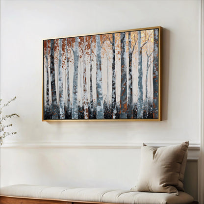 a large framed painting of a forest scene hanging on a white wall above a wooden bench.