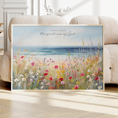 a framed painting of a field of colorful flowers, with a serene ocean view in the background.