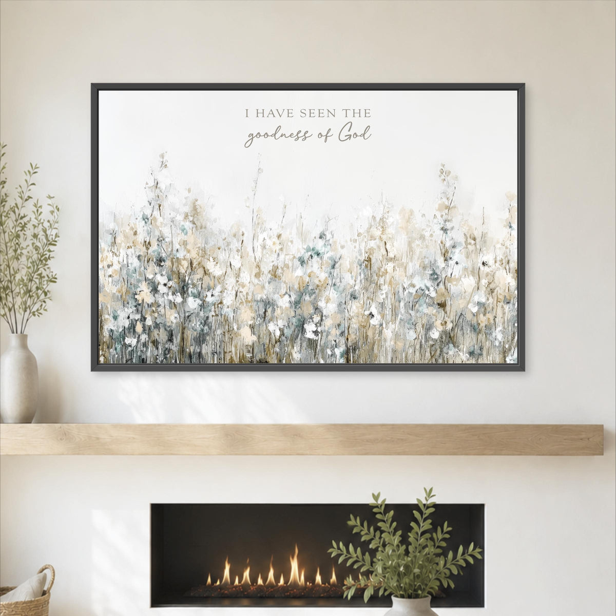 a framed artwork of a field of flowers hanging on a wall above a fireplace.