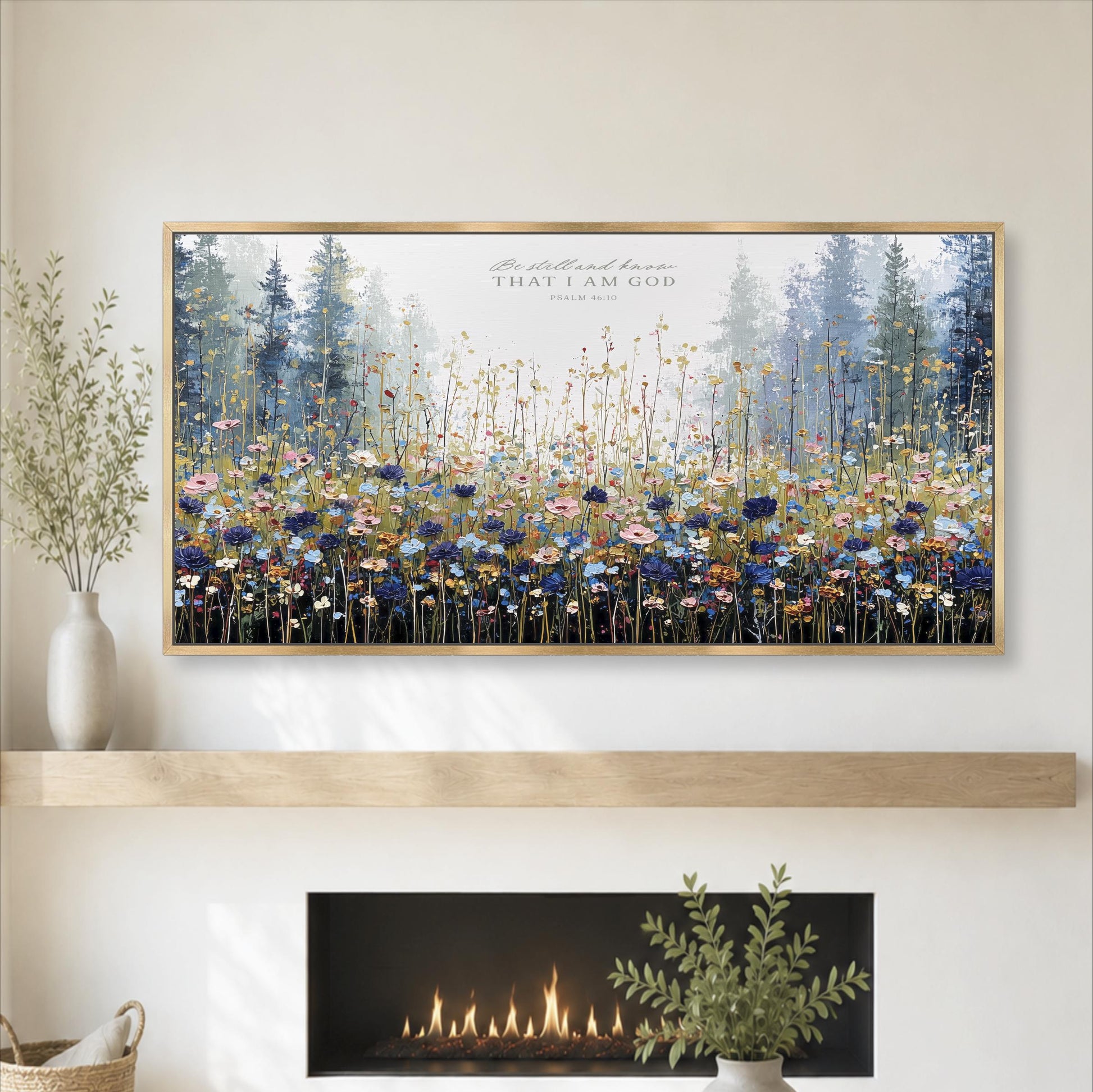 a large framed painting of a field of flowers hanging on a wall above a fireplace.