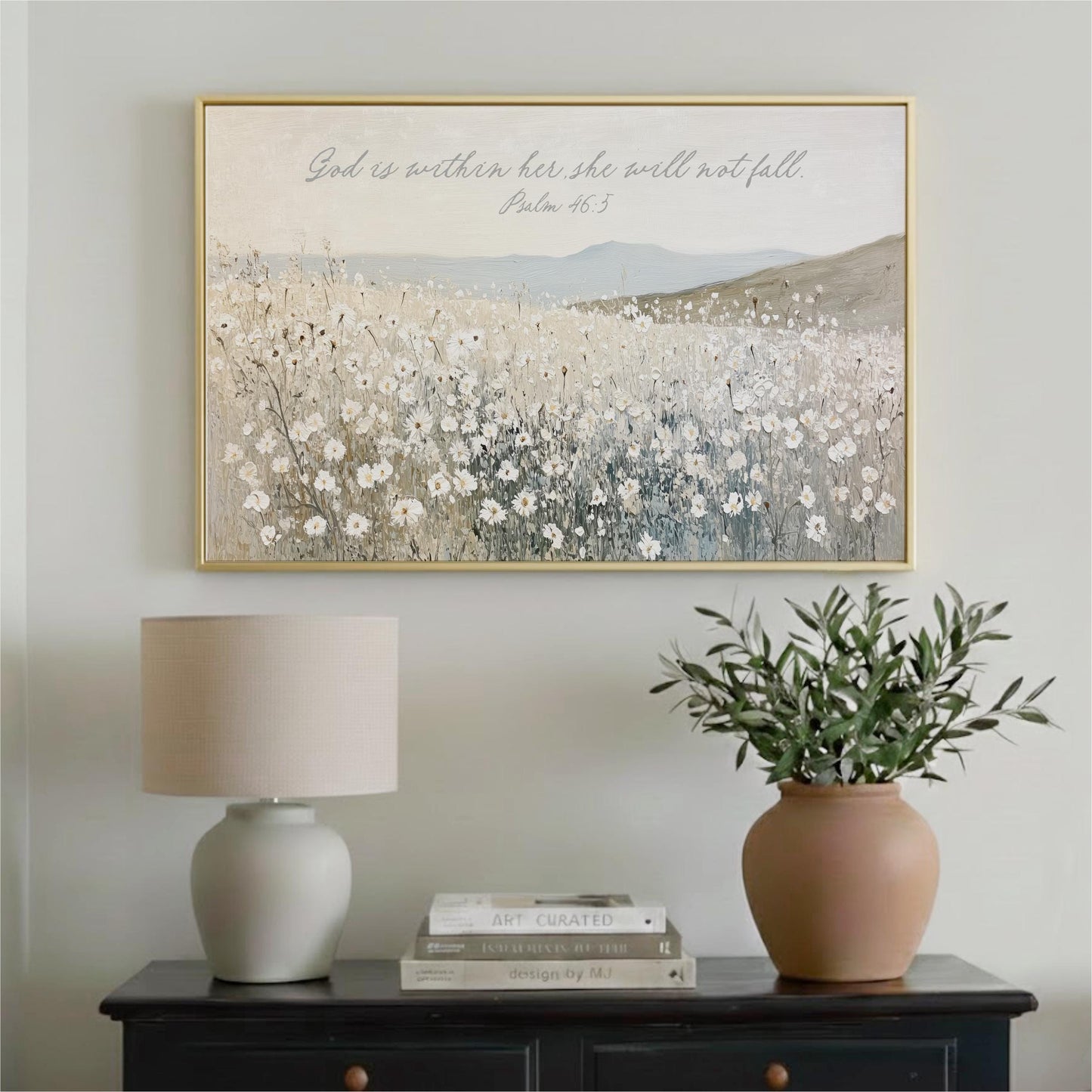a framed painting of a field of flowers hanging on a wall above a black dresser with a lamp and a potted plant.