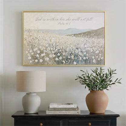 a framed painting of a field of flowers hanging on a wall above a black dresser with a lamp and a potted plant.