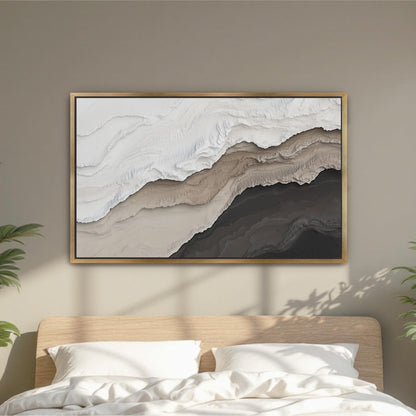 a large abstract painting hanging on a wall above a bed with white pillows.