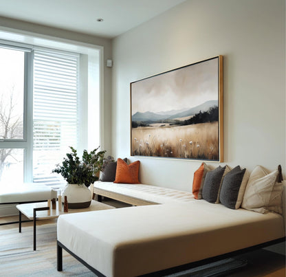 a modern living room with a large window, a white sofa with orange and gray throw pillows, and a large landscape painting on the wall.