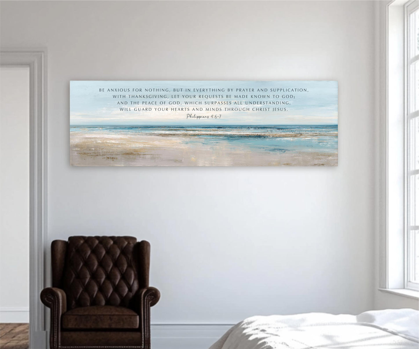 a large canvas print of a serene beach scene, hanging on a white wall in a room with a brown leather chair in the foreground.
